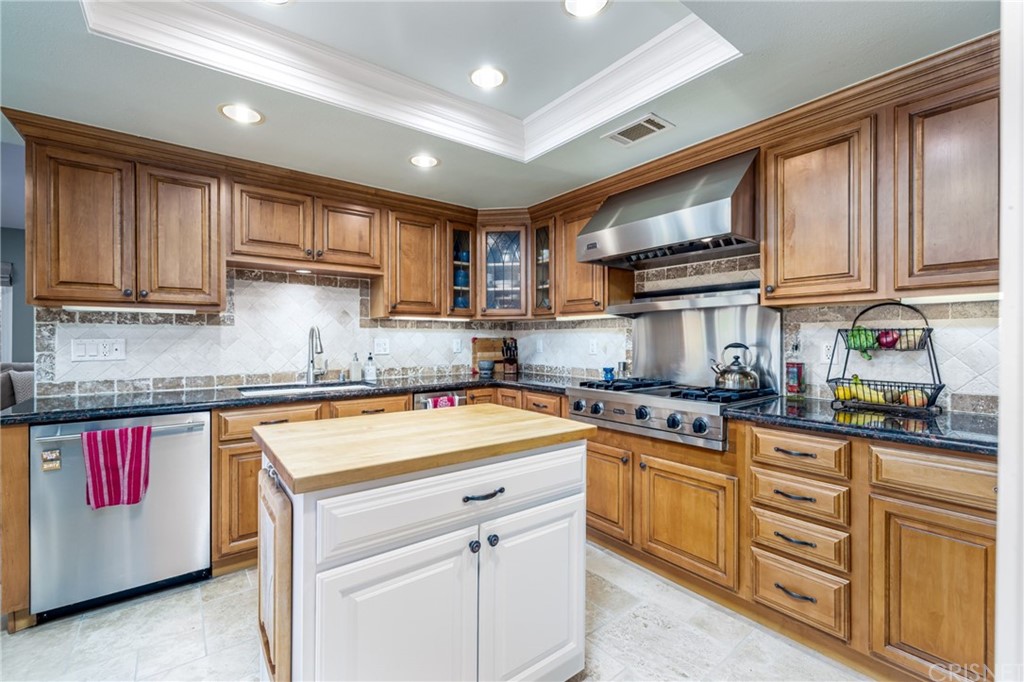 18261 Hiawatha Street Northridge, CA 91326 - Photo 16 of 35 a kitchen with stainless steel appliances granite countertop a stove sink and cabinets