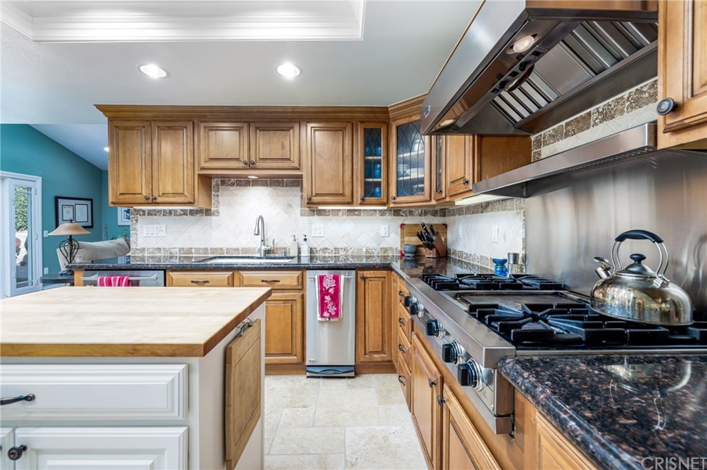 18261 Hiawatha Street Northridge, CA 91326 - Photo 17 of 35 a kitchen with stainless steel appliances granite countertop a stove and a sink