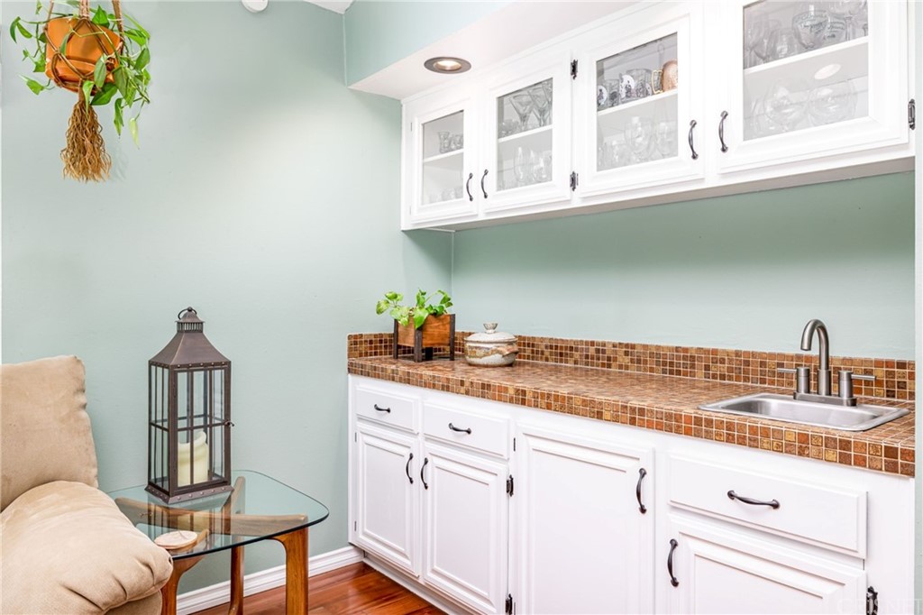 18261 Hiawatha Street Northridge, CA 91326 - Photo 21 of 35 a kitchen with stainless steel appliances white cabinets and a window