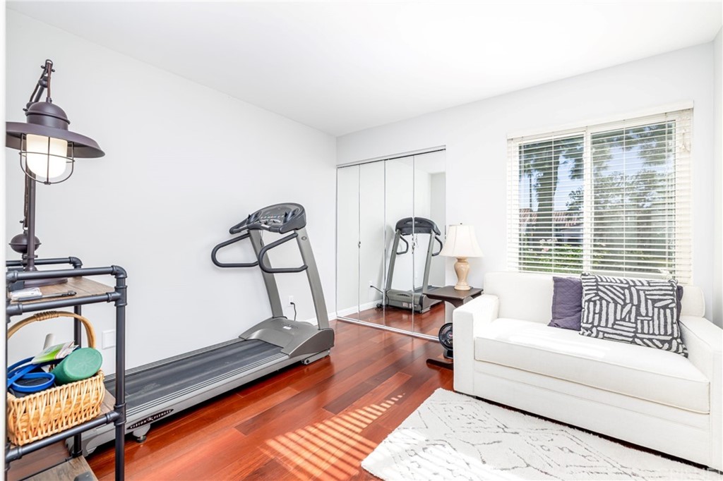 18261 Hiawatha Street Northridge, CA 91326 - Photo 22 of 35 a living room with furniture gym equipment and a window