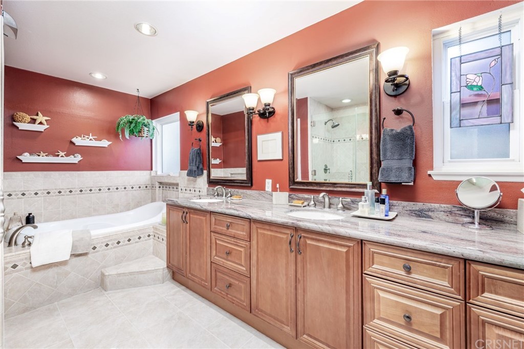 18261 Hiawatha Street Northridge, CA 91326 - Photo 27 of 35 a bathroom with a granite countertop double vanity sink and a large mirror