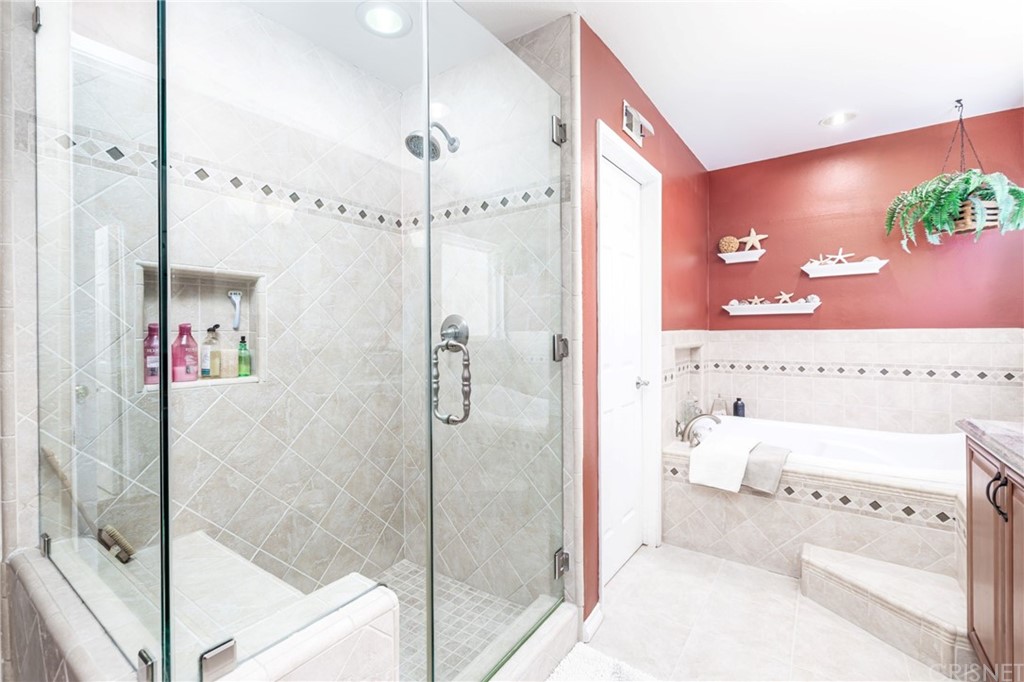 18261 Hiawatha Street Northridge, CA 91326 - Photo 28 of 35 a bathroom with a bathtub and a shower