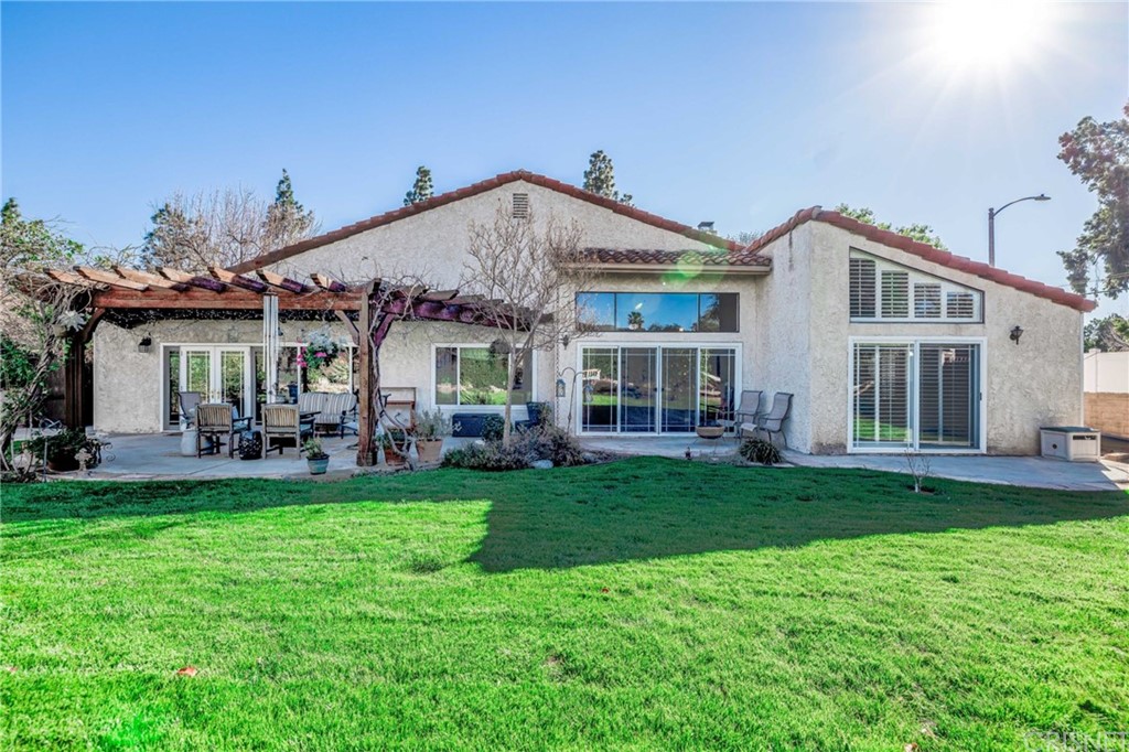 18261 Hiawatha Street Northridge, CA 91326 - Photo 31 of 35 a front view of a house with a garden and patio