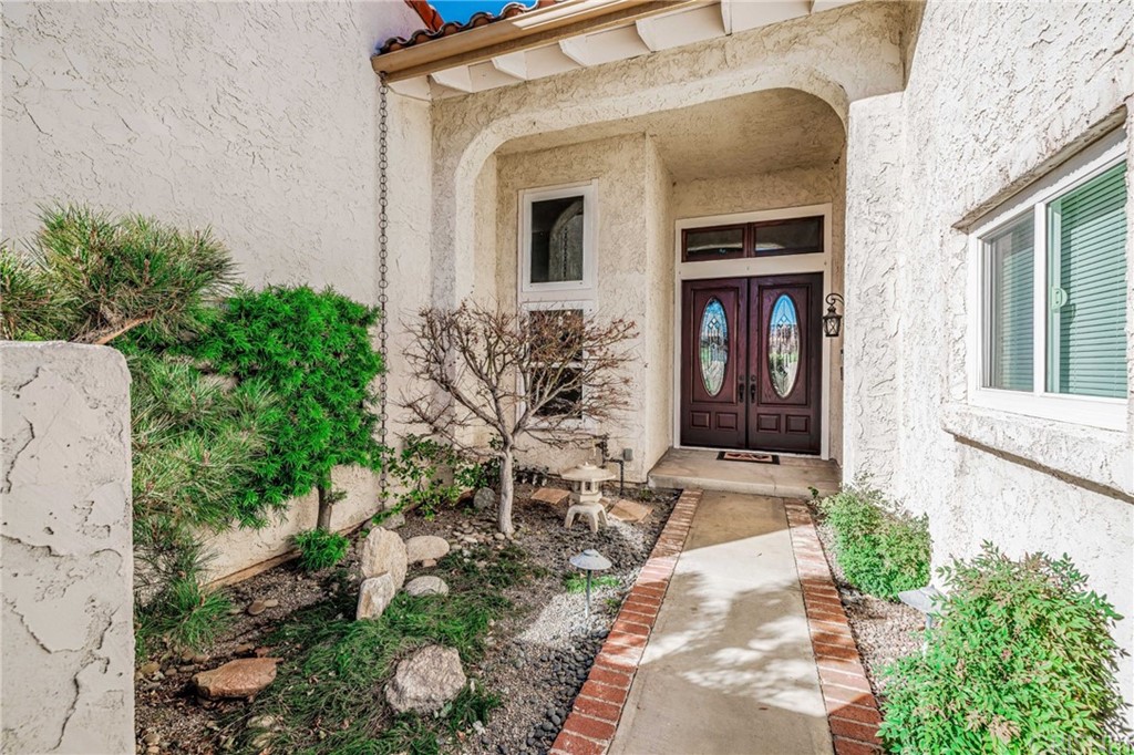 18261 Hiawatha Street Northridge, CA 91326 - Photo 4 of 35 a front view of a house with a yard