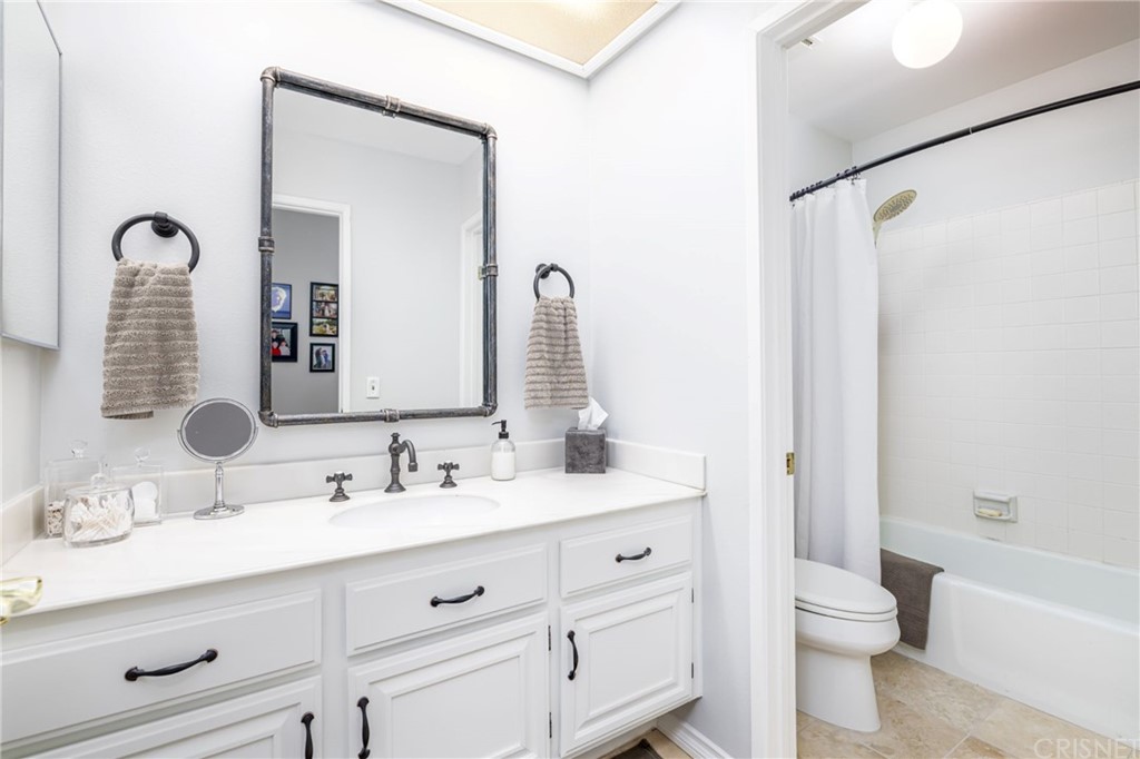 18261 Hiawatha Street Northridge, CA 91326 - Photo 10 of 35 a bathroom with a double vanity sink toilet and shower