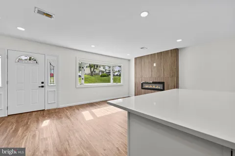 a view of a kitchen with wooden floor and a refrigerator