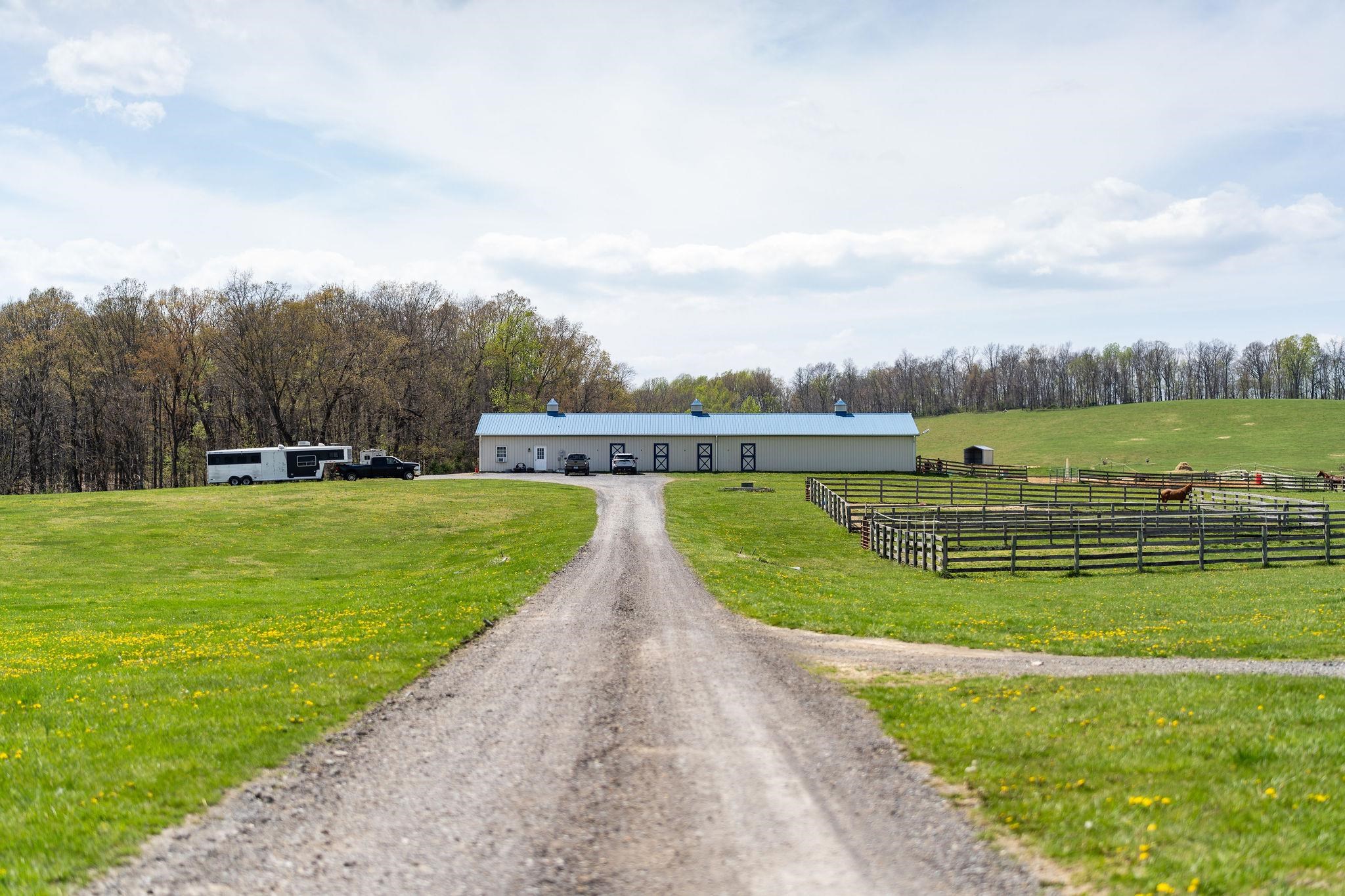 309 Old B&O Road Raphine, VA 24472 - Photo 73 of 75 a view of a swimming pool with a garden and trees in the background