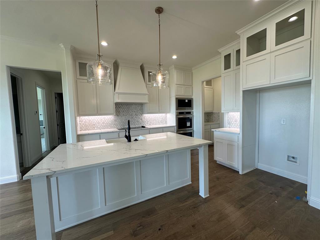 116 Blackstar Lane Decatur, TX 76234 - Photo 12 of 32 a large white kitchen with stainless steel appliances granite countertop a sink a stove and a refrigerator