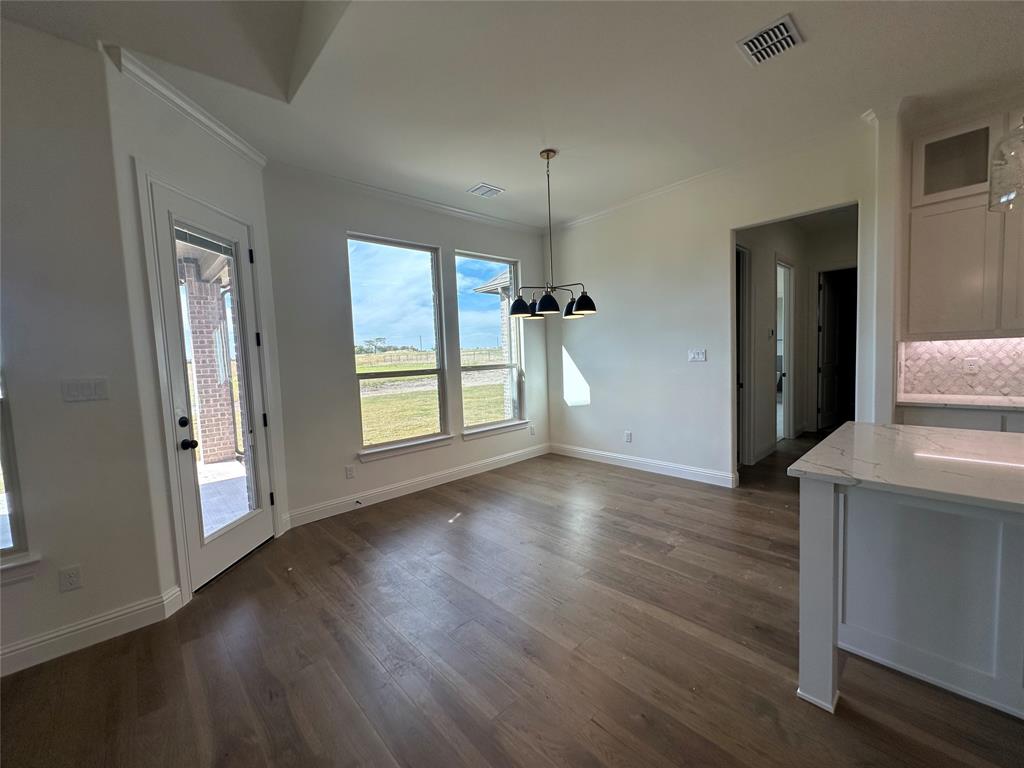 116 Blackstar Lane Decatur, TX 76234 - Photo 13 of 32 an empty room with wooden floor and windows