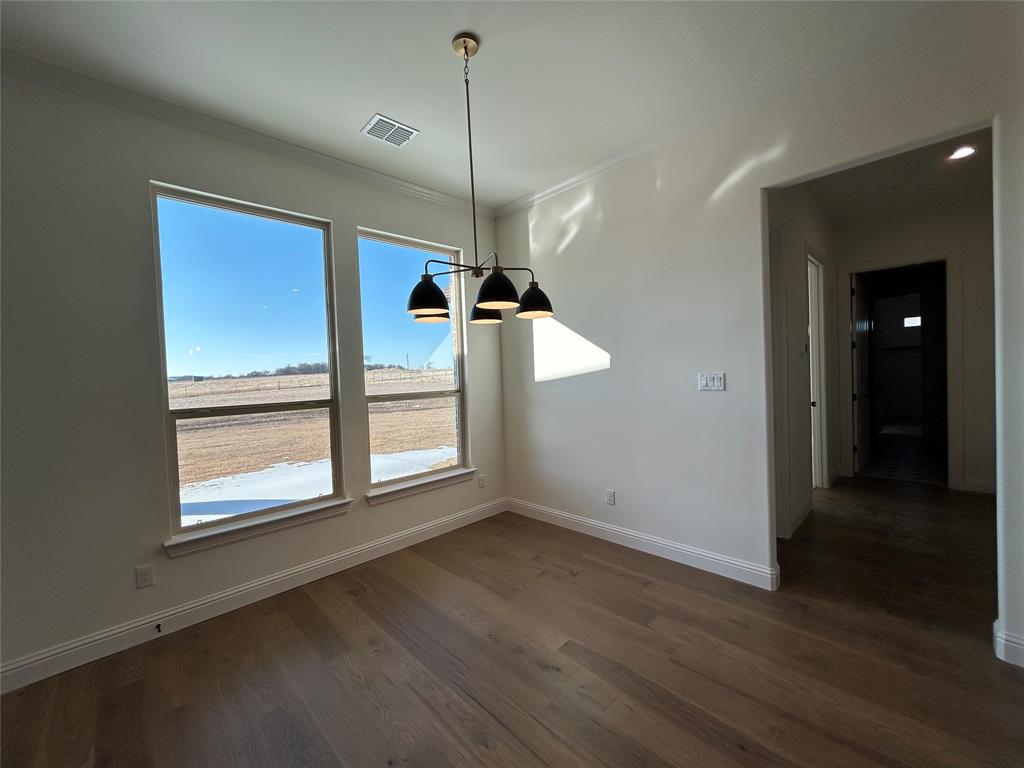 116 Blackstar Lane Decatur, TX 76234 - Photo 14 of 32 an empty room with wooden floor fan and windows