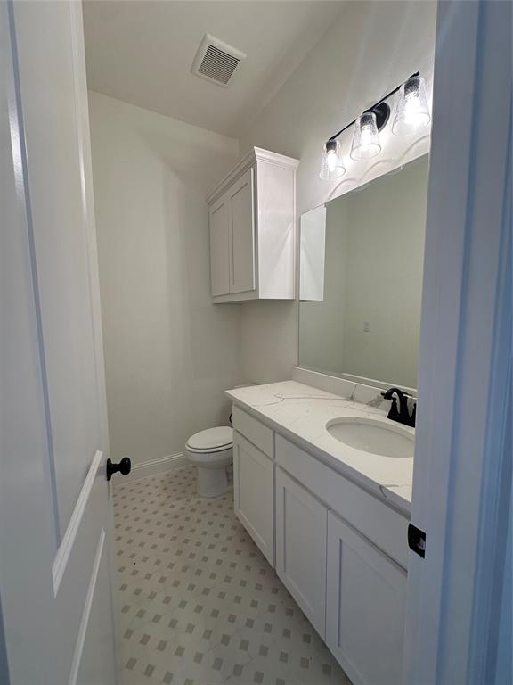 116 Blackstar Lane Decatur, TX 76234 - Photo 22 of 32 a bathroom with a sink a toilet and a mirror