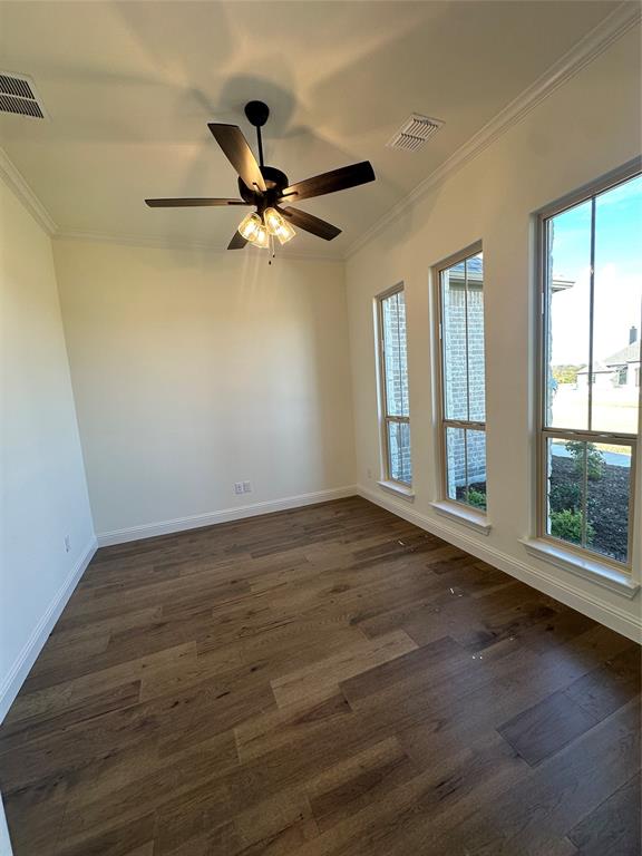 116 Blackstar Lane Decatur, TX 76234 - Photo 5 of 32 an empty room with wooden floor fan and windows