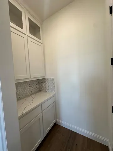 a large kitchen with kitchen island a stove a refrigerator a sink dishwasher with a dining table and chairs with wooden floor