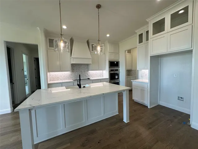 an empty room with fireplace wooden floor and windows