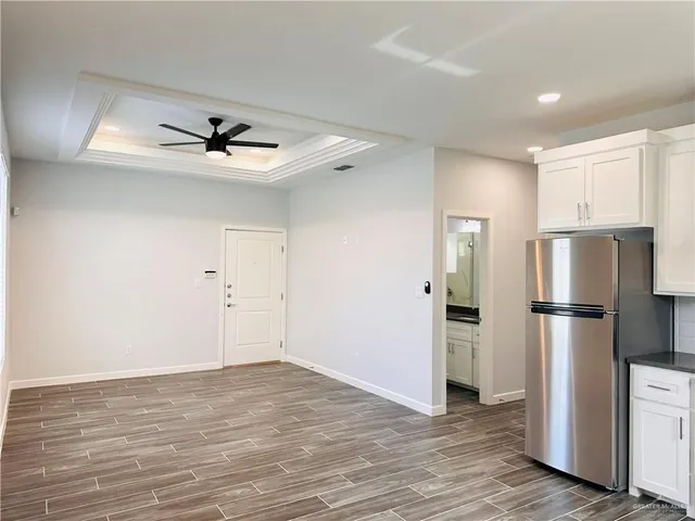 a view of kitchen with stainless steel appliances a refrigerator and a stove