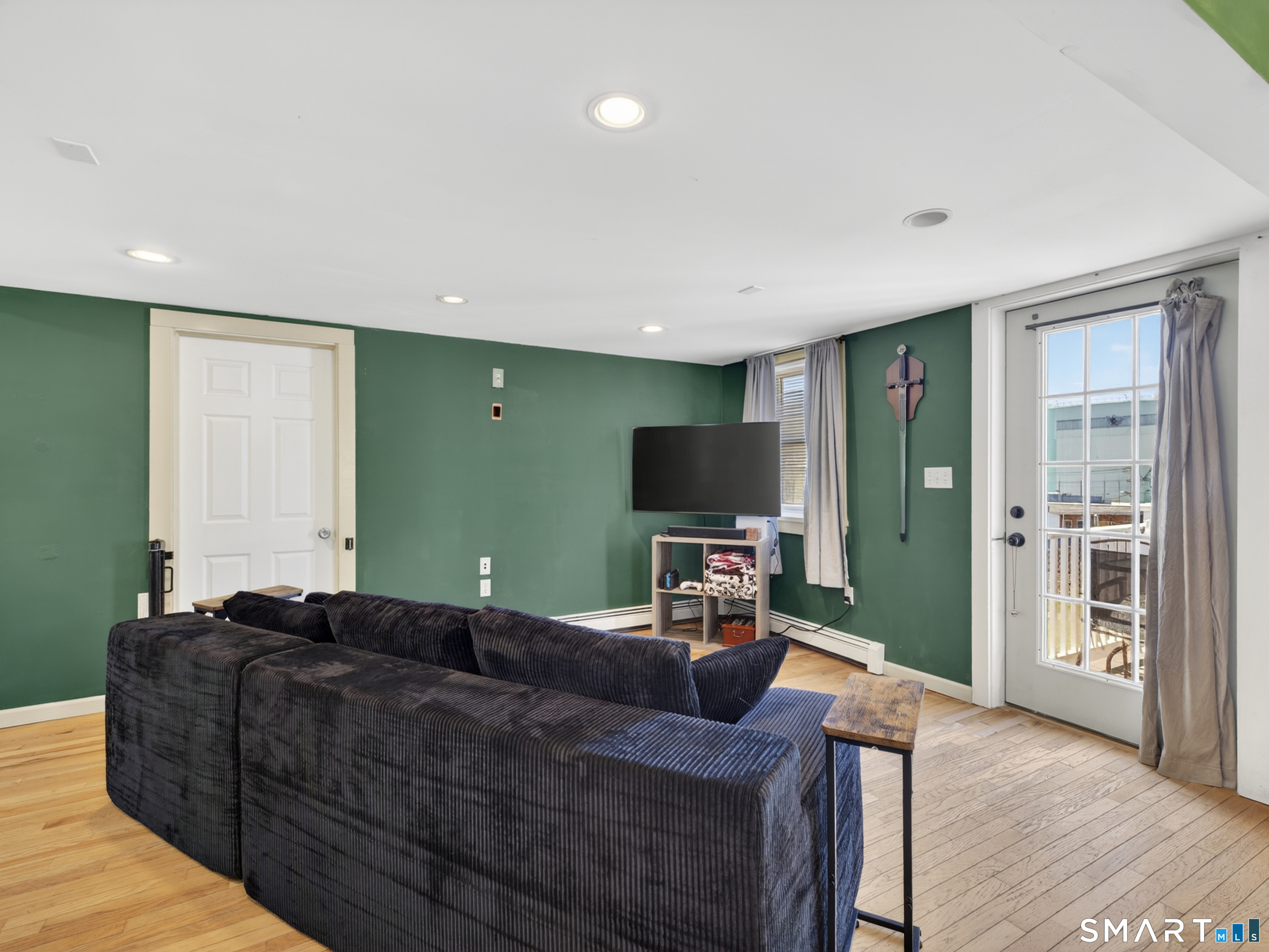 13 Oak Street Groton, CT 06340 - Photo 10 of 38 a living room with furniture and a flat screen tv