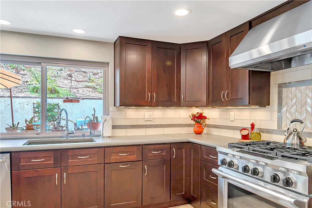 28604 Eagleton Street Agoura Hills, CA 91301 - Photo 24 of 72 a kitchen with stainless steel appliances a sink stove and cabinets