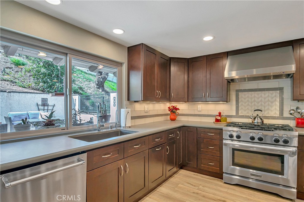 28604 Eagleton Street Agoura Hills, CA 91301 - Photo 25 of 72 a kitchen with a sink stove top oven and cabinets