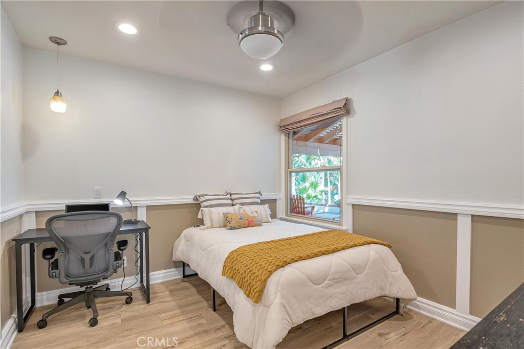28604 Eagleton Street Agoura Hills, CA 91301 - Photo 30 of 72 a bedroom with a bed a chair and a chandelier