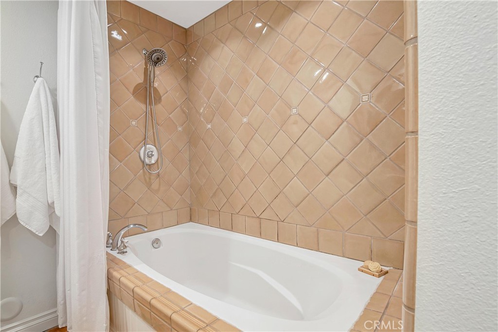 28604 Eagleton Street Agoura Hills, CA 91301 - Photo 44 of 72 a bathroom with a white bath tub and a shower curtain