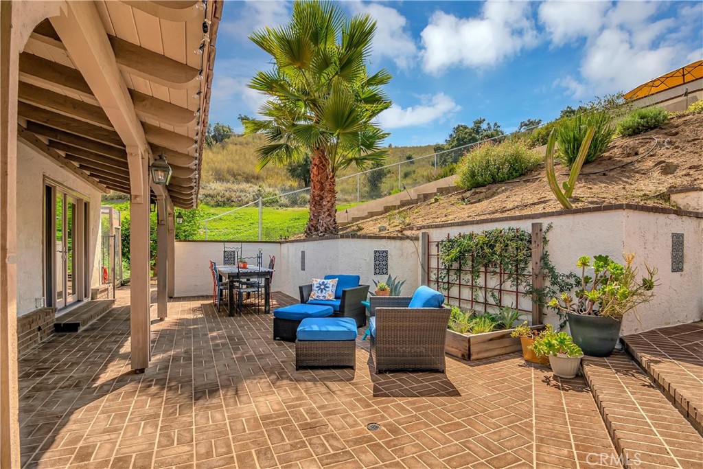 28604 Eagleton Street Agoura Hills, CA 91301 - Photo 50 of 72 a view of a patio with table and chairs potted plants