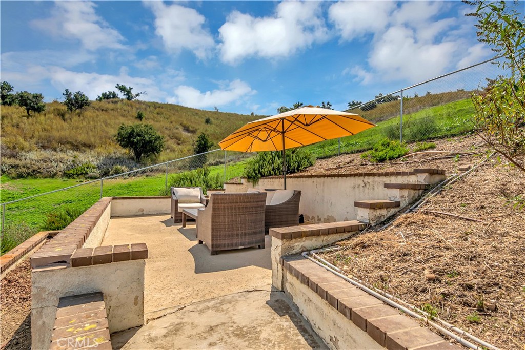 28604 Eagleton Street Agoura Hills, CA 91301 - Photo 61 of 72 a view of a patio with chairs under an umbrella