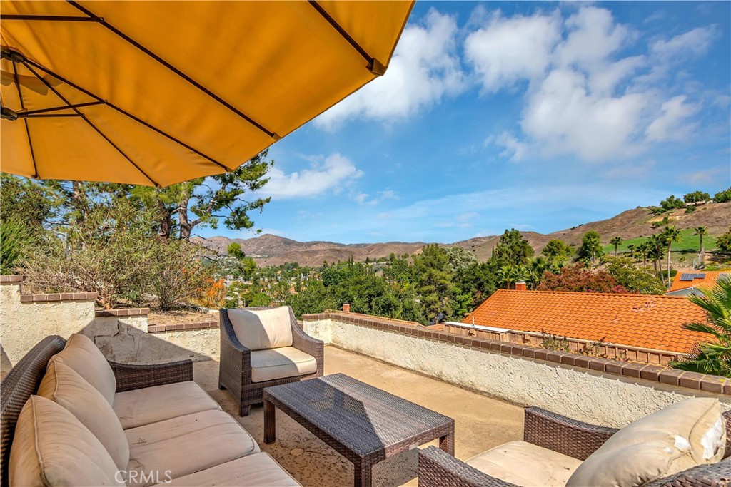 28604 Eagleton Street Agoura Hills, CA 91301 - Photo 62 of 72 a view of a balcony with mountain view and wooden floor