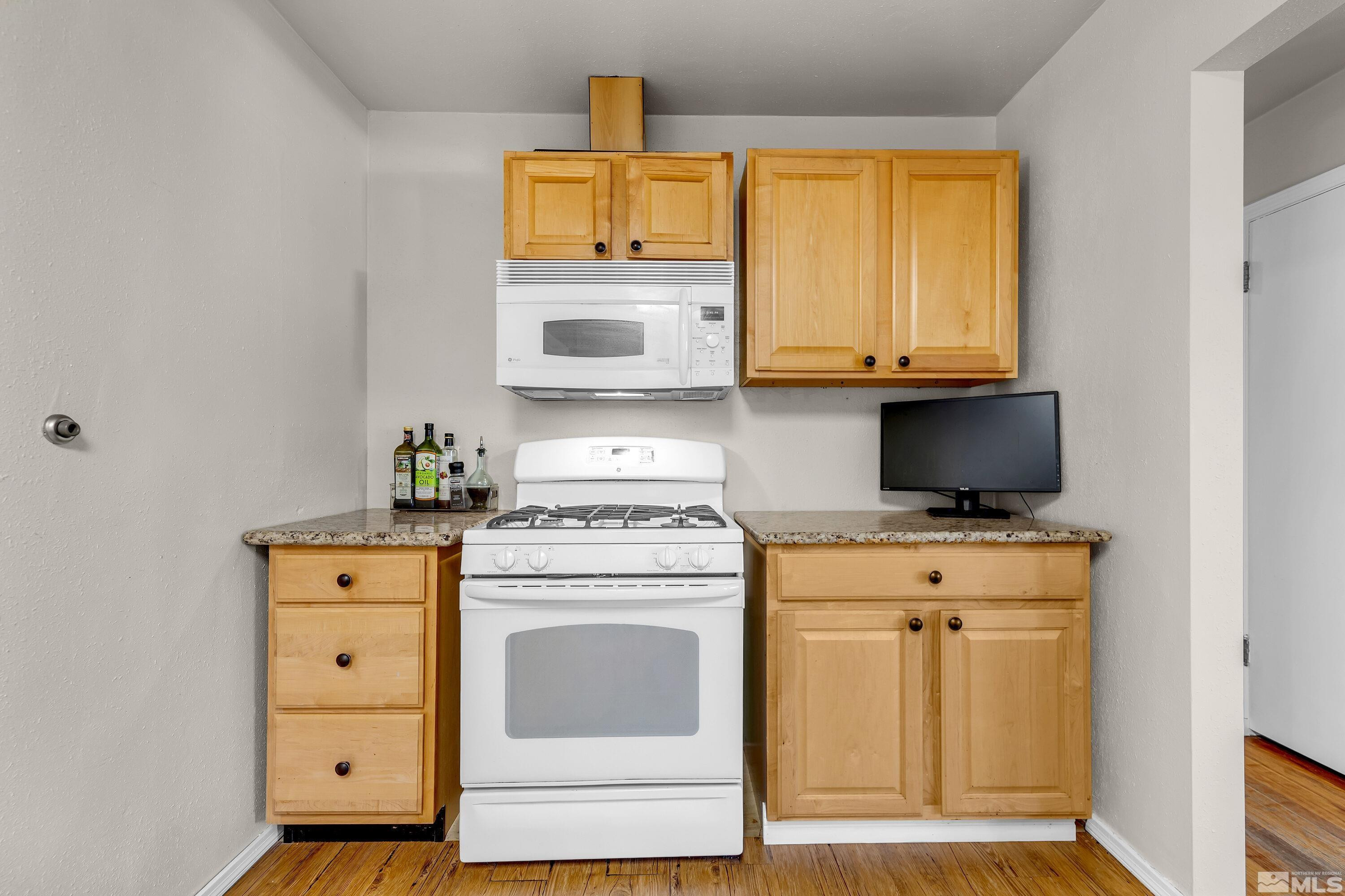 1615 Keystone Avenue Reno, NV 89503 - Photo 14 of 40 a kitchen with a stove and a microwave