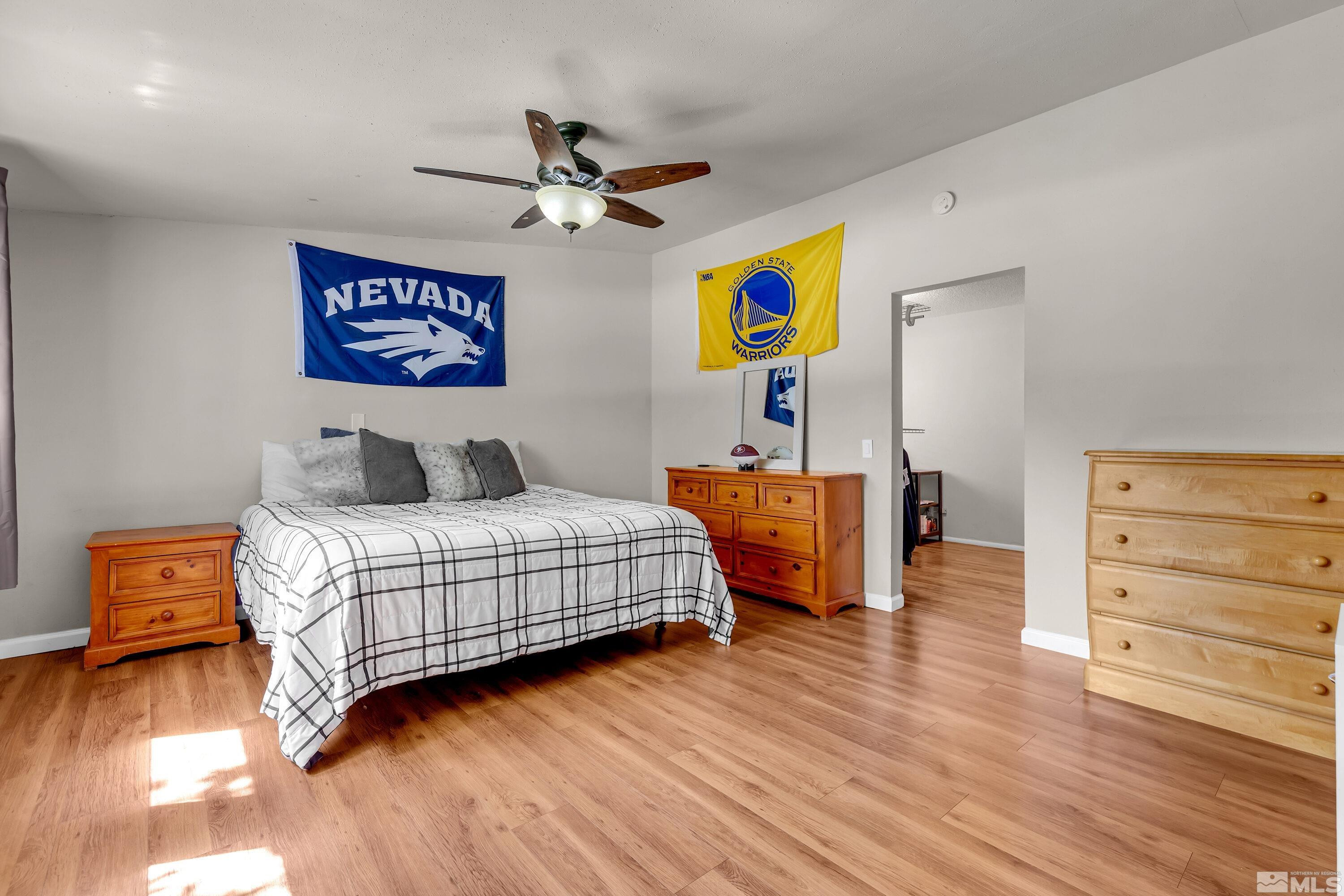 1615 Keystone Avenue Reno, NV 89503 - Photo 15 of 40 a bedroom with a bed and wooden floor