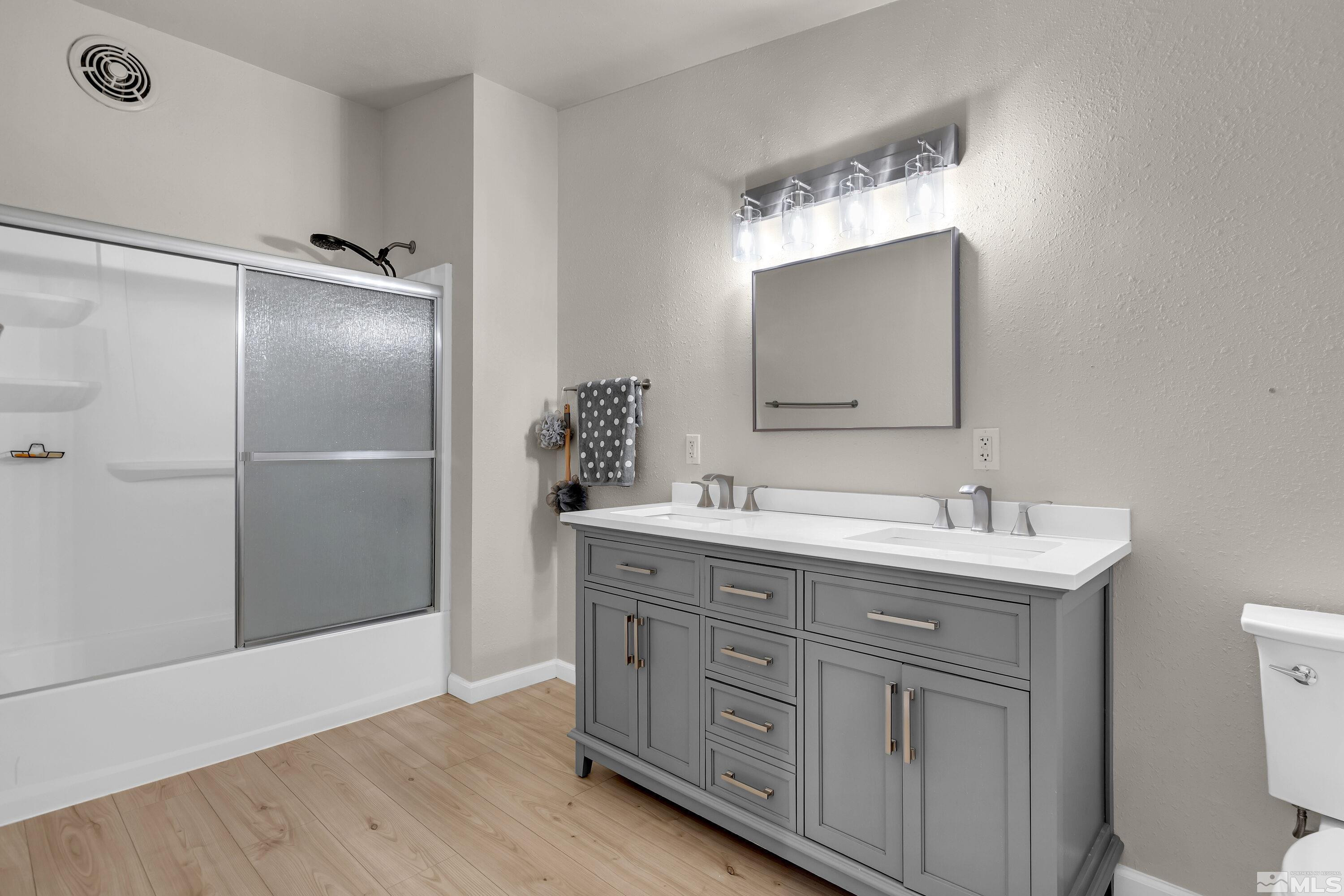 1615 Keystone Avenue Reno, NV 89503 - Photo 21 of 40 a bathroom with a double vanity sink and mirror