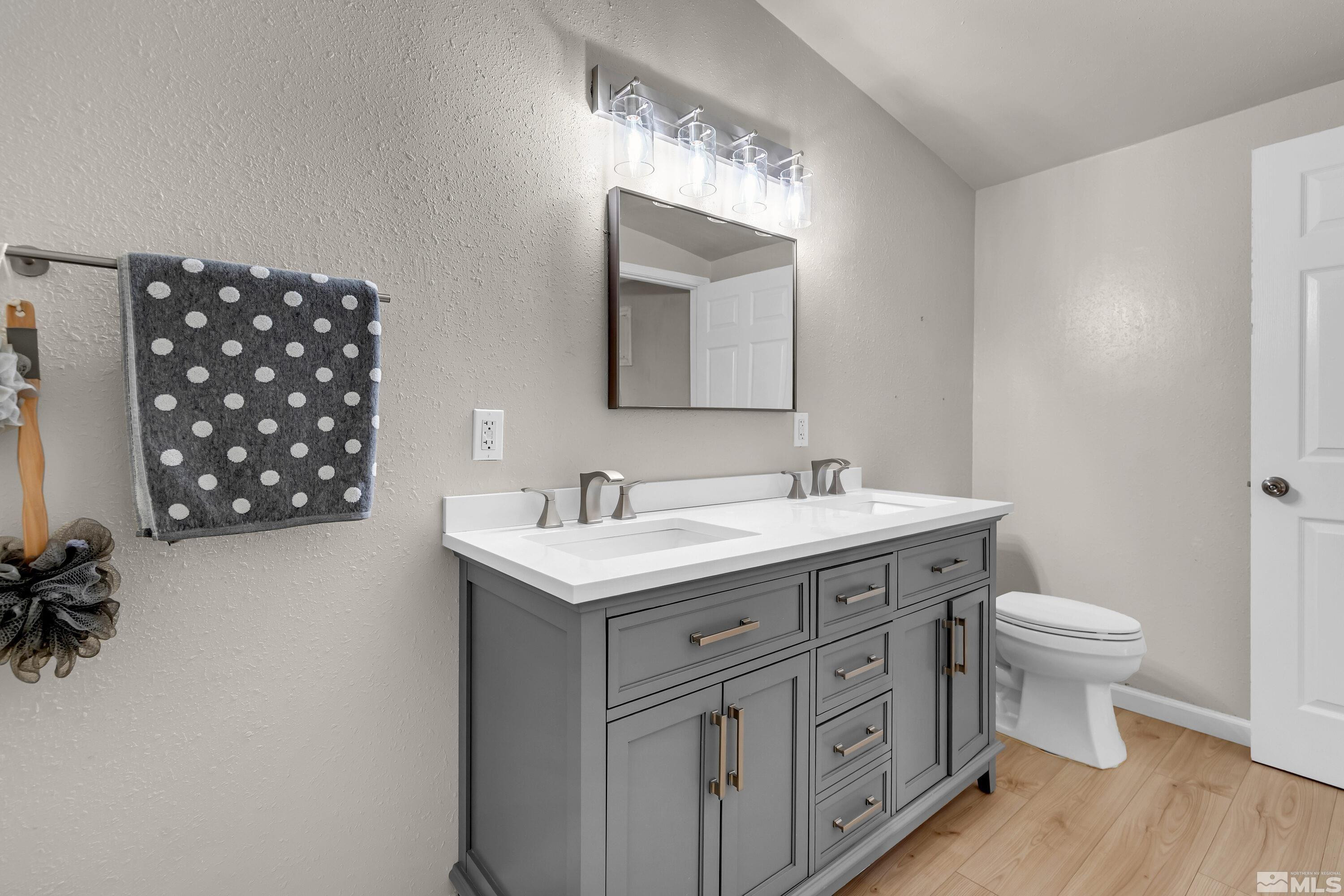 1615 Keystone Avenue Reno, NV 89503 - Photo 22 of 40 a spacious bathroom with a double vanity sink a toilet and a mirror