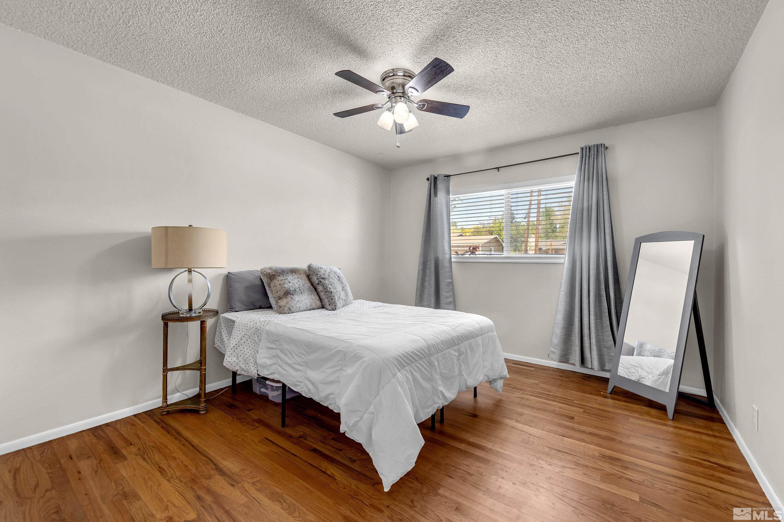 1615 Keystone Avenue Reno, NV 89503 - Photo 23 of 40 a bed room with a bed and a chandelier