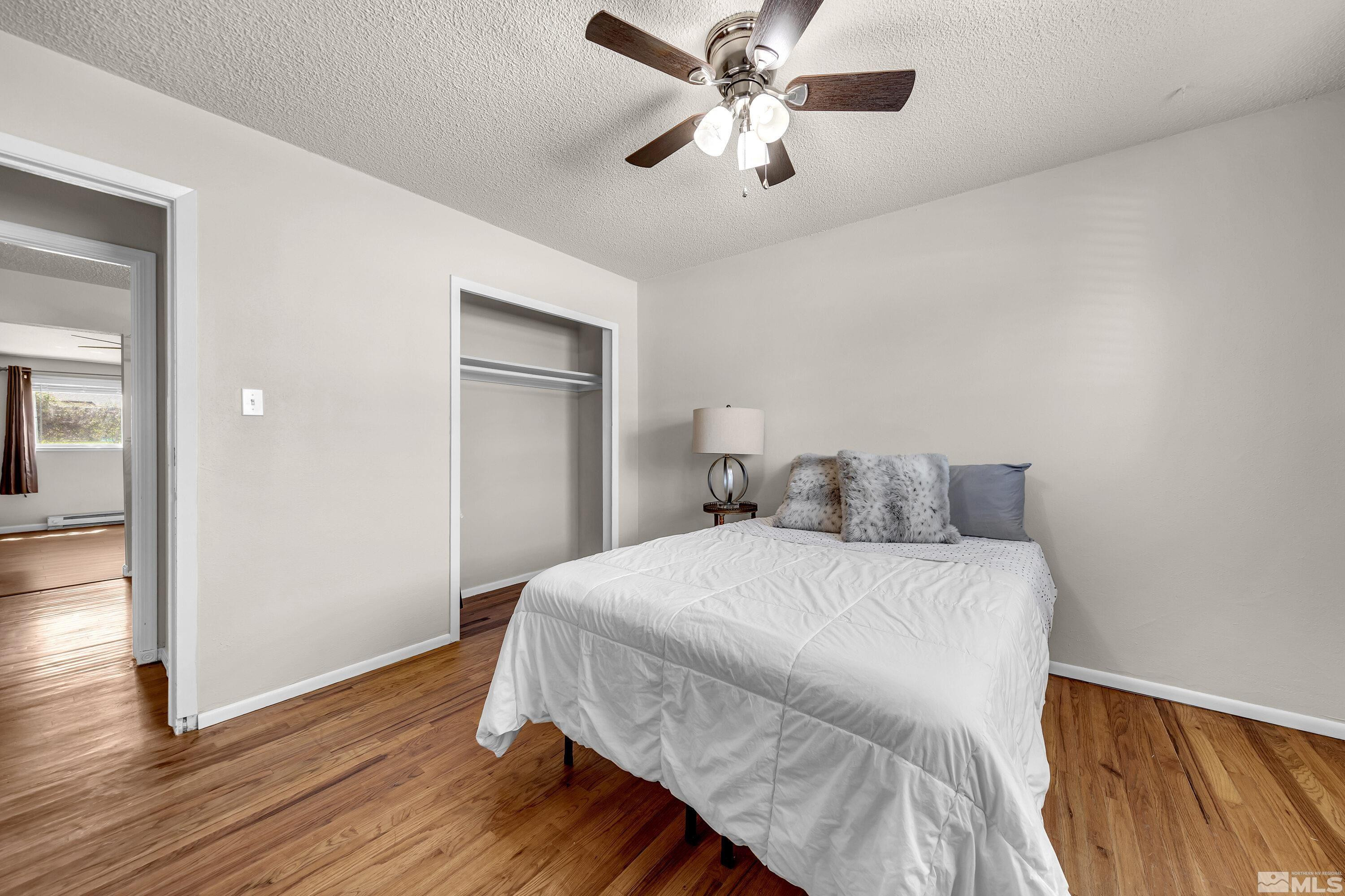1615 Keystone Avenue Reno, NV 89503 - Photo 24 of 40 a bedroom with a bed and wooden floor