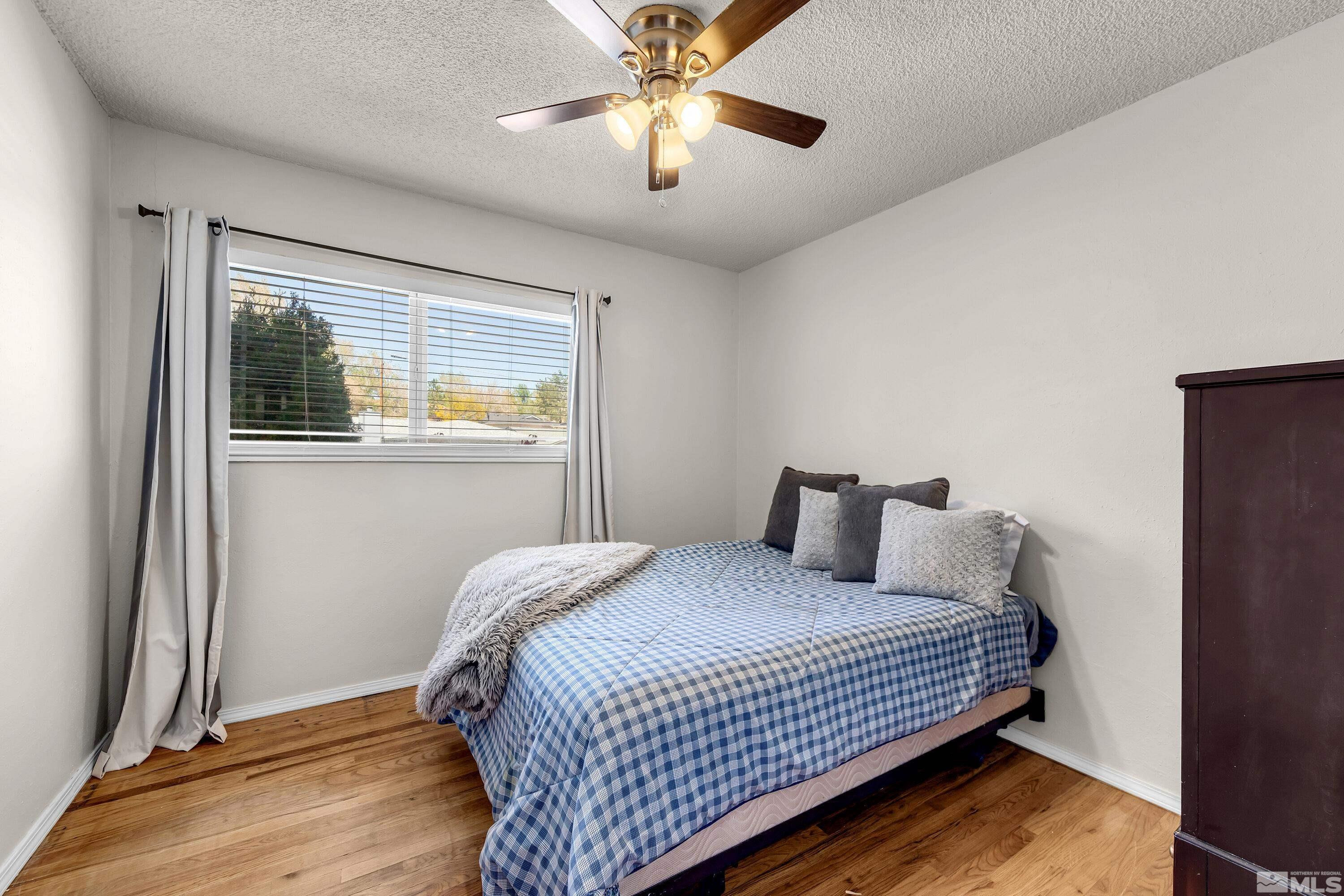 1615 Keystone Avenue Reno, NV 89503 - Photo 26 of 40 a bedroom with a bed and a chandelier