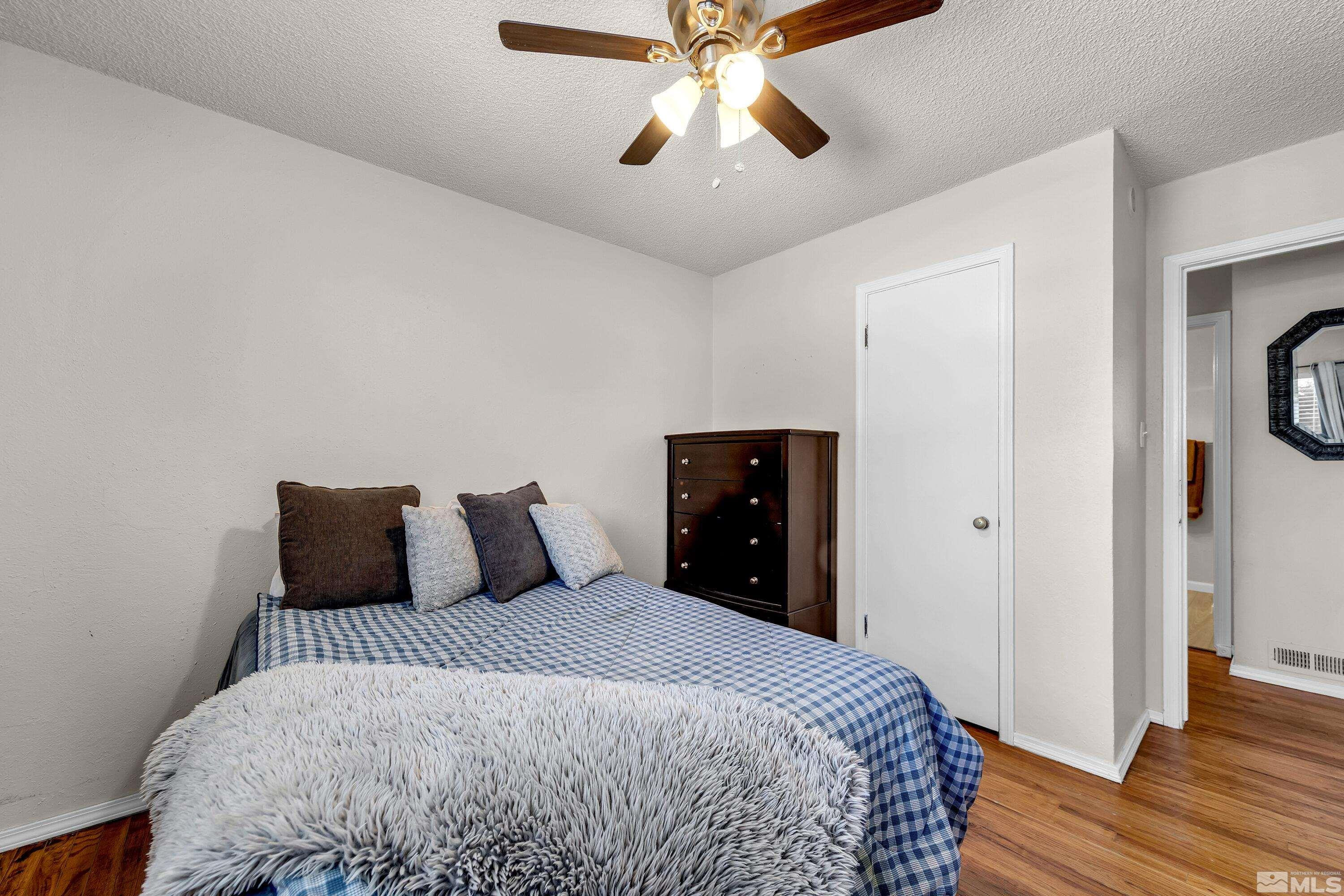 1615 Keystone Avenue Reno, NV 89503 - Photo 27 of 40 a bedroom with a bed and wooden floor