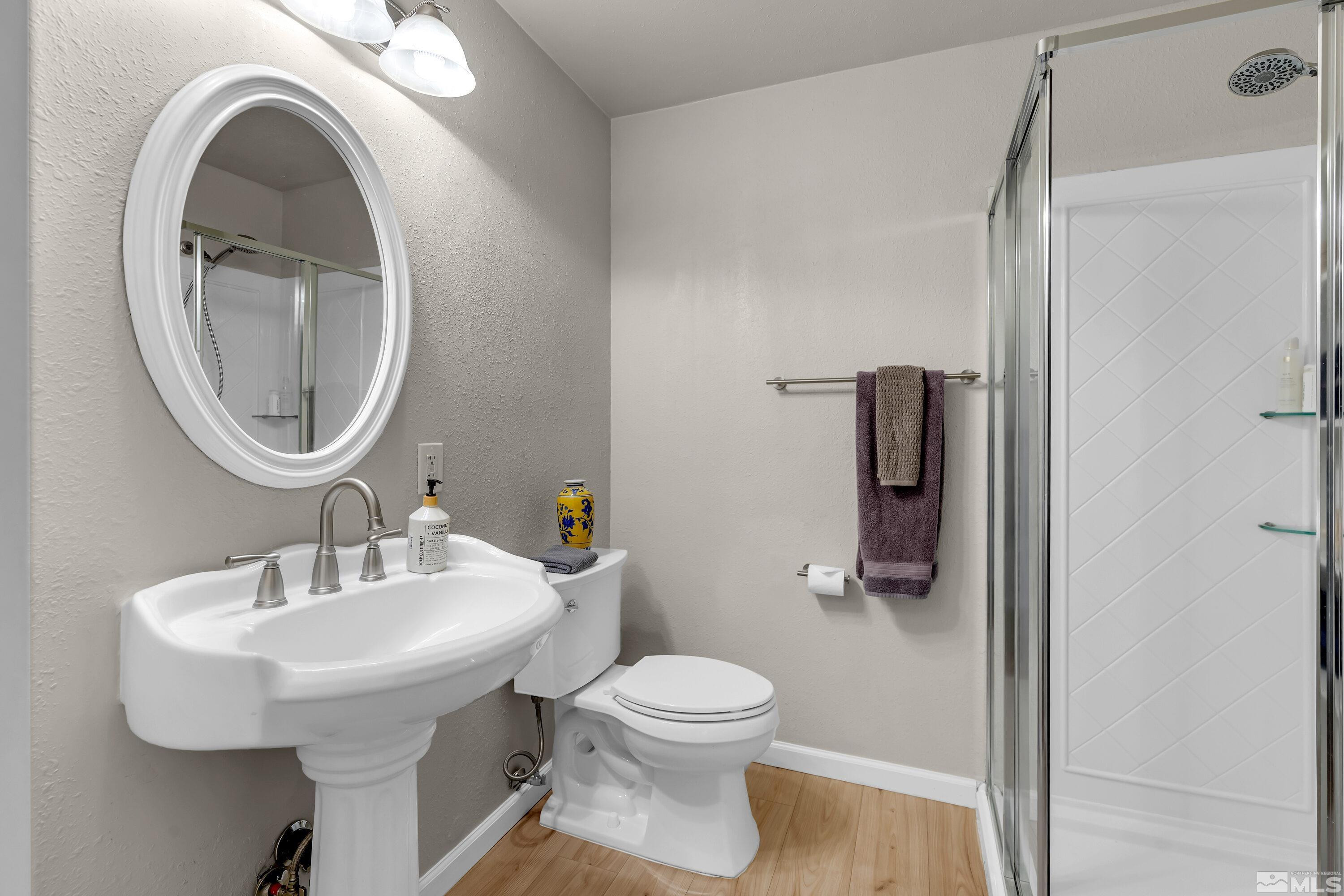 1615 Keystone Avenue Reno, NV 89503 - Photo 28 of 40 a bathroom with a sink a toilet and a mirror