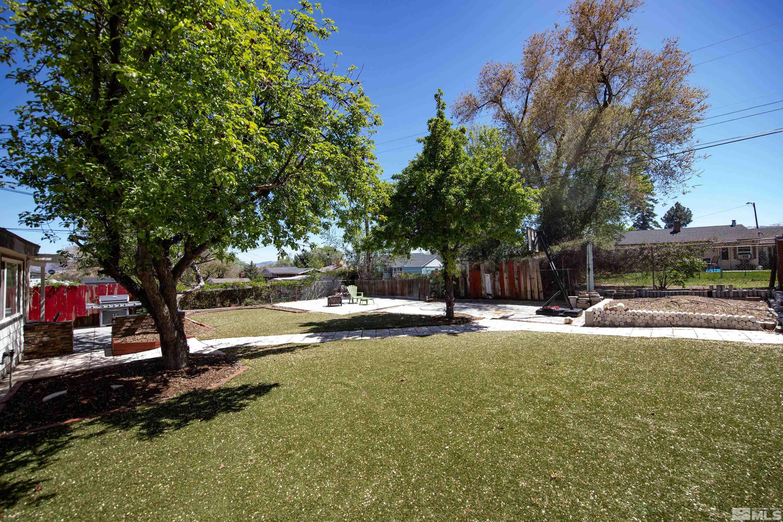 1615 Keystone Avenue Reno, NV 89503 - Photo 32 of 40 a view of a swimming pool with a bench and trees around
