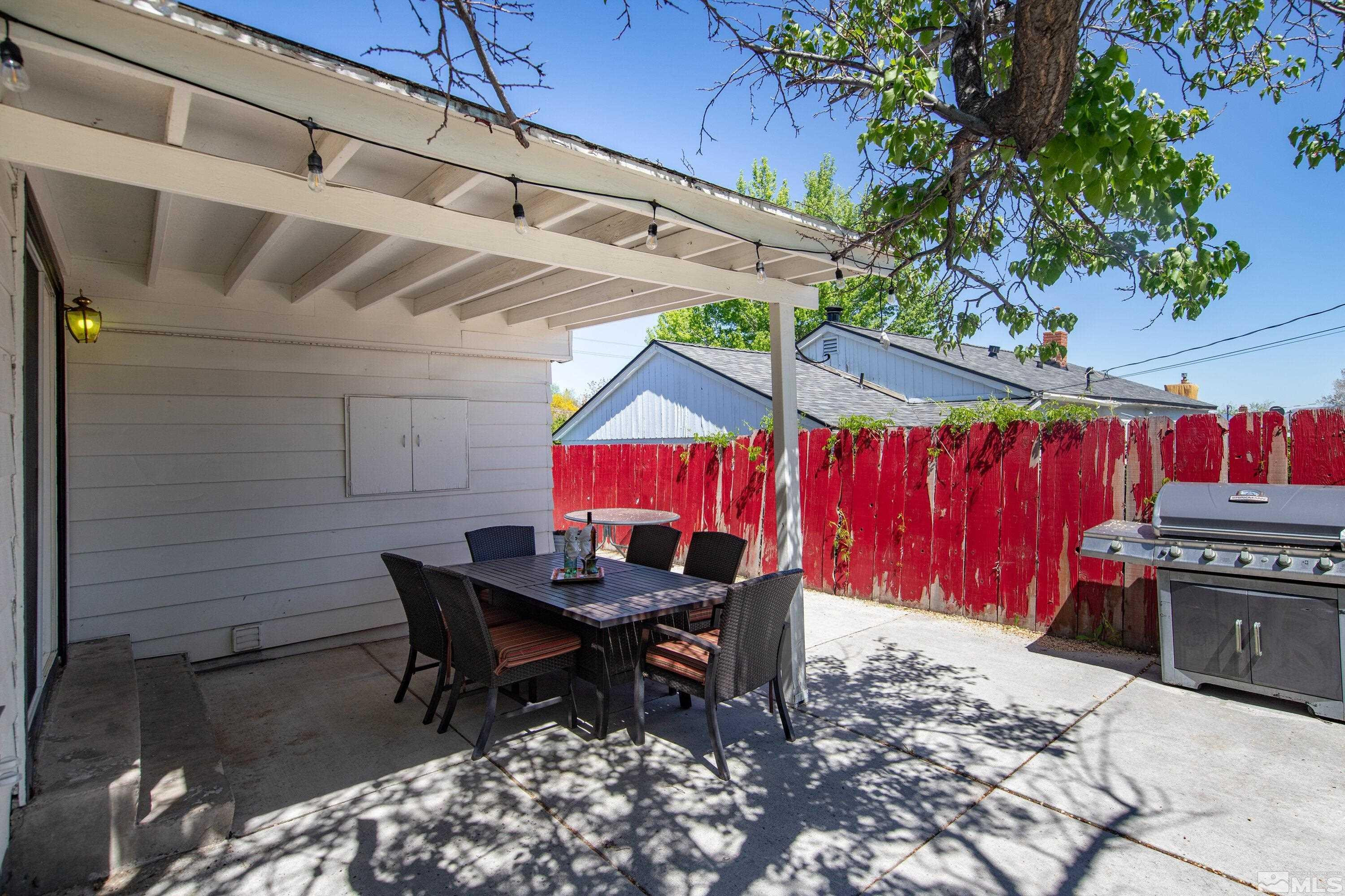 1615 Keystone Avenue Reno, NV 89503 - Photo 37 of 40 a view of a backyard with table and chairs with wooden floor