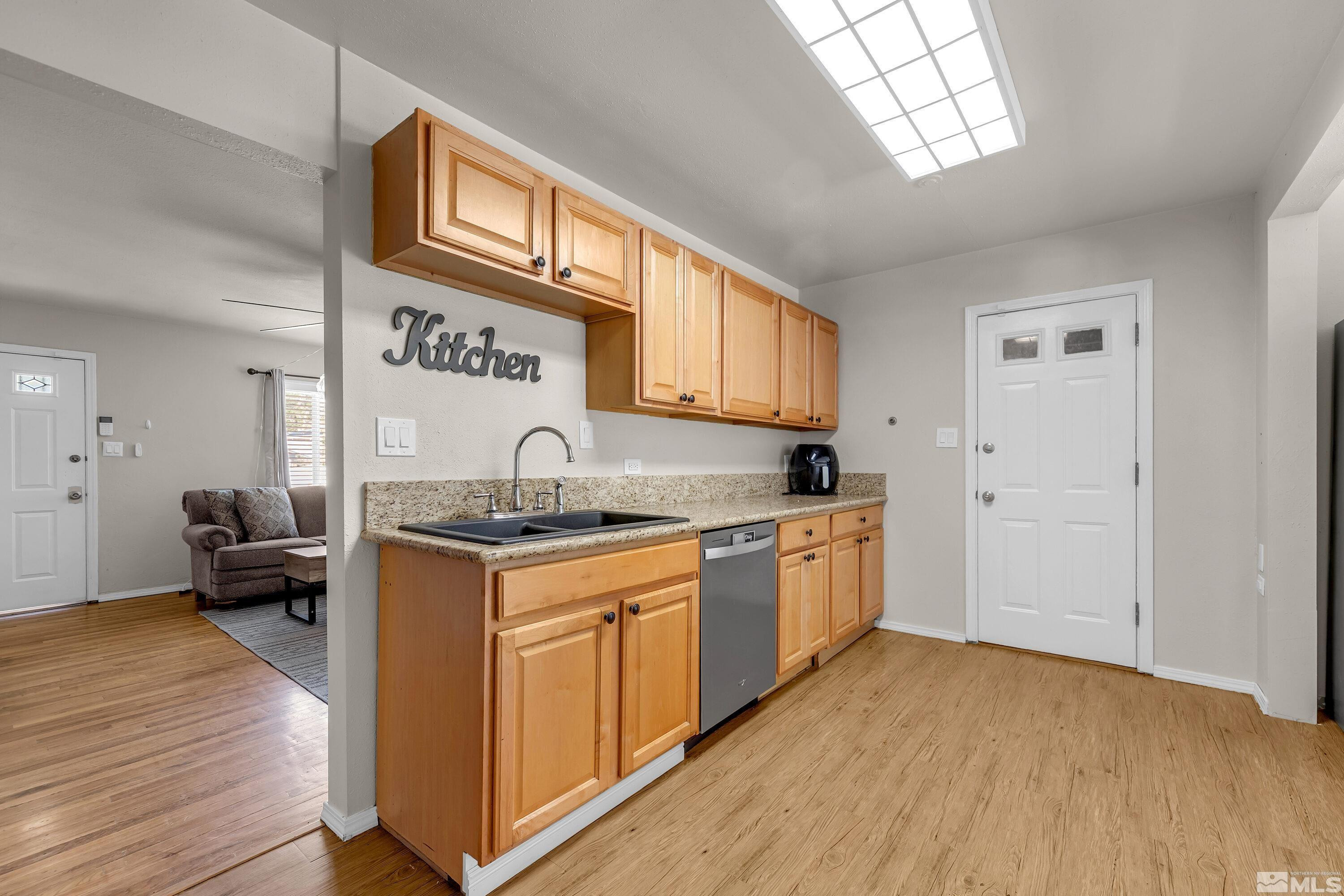 1615 Keystone Avenue Reno, NV 89503 - Photo 7 of 40 a kitchen with granite countertop a stove a sink and a refrigerator