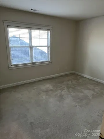 an empty room with closet and wooden floor