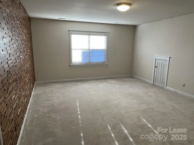 a view of an empty room with windows