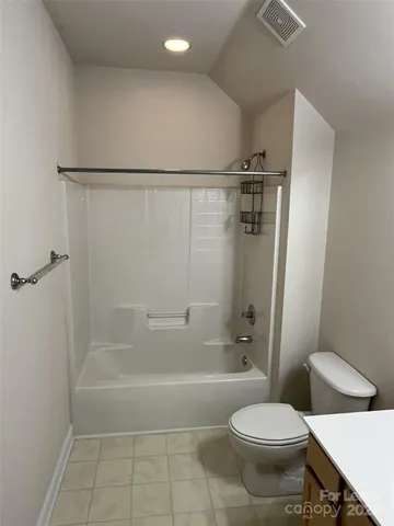 a view of a house with a wooden deck