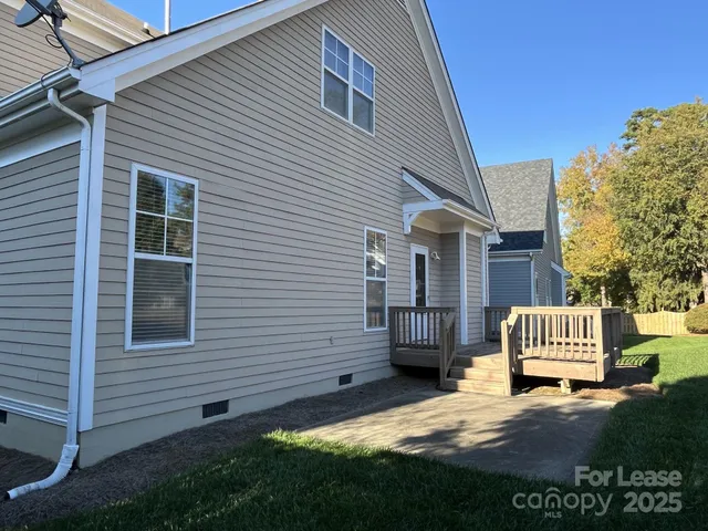 a view of a yard with wooden fence