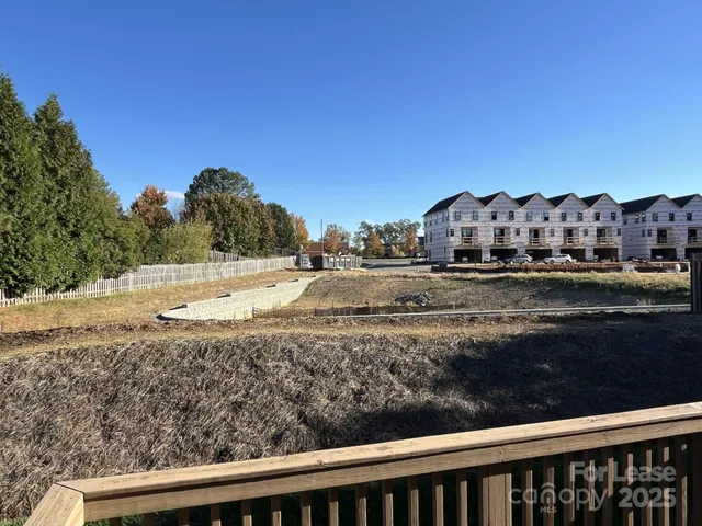 a view of a yard with plants and trees