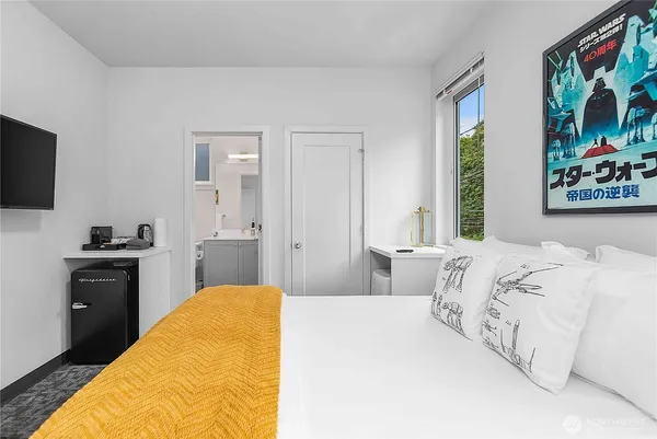a bedroom with a bed and a flat screen tv