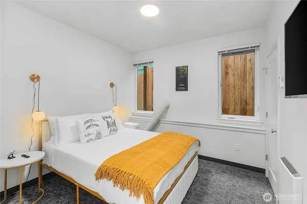a bedroom with a bed and a window
