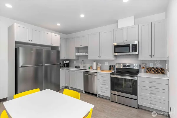 a kitchen with stainless steel appliances a stove a refrigerator and a sink