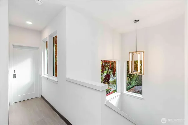 a view of an entryway with wooden floor