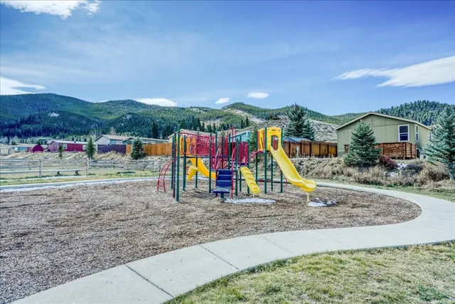 a view of a park with swings and slides