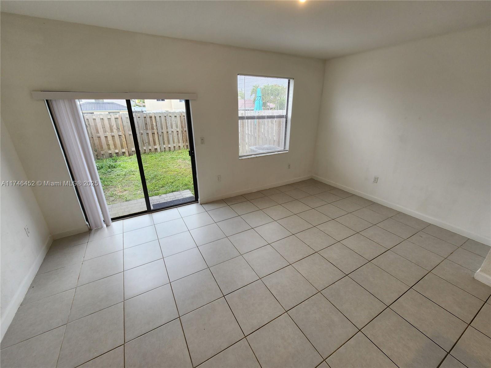 18232 Southwest 148th Road, Unit 18232 Miami, FL 33187 - Photo 14 of 44 a view of an empty room and window